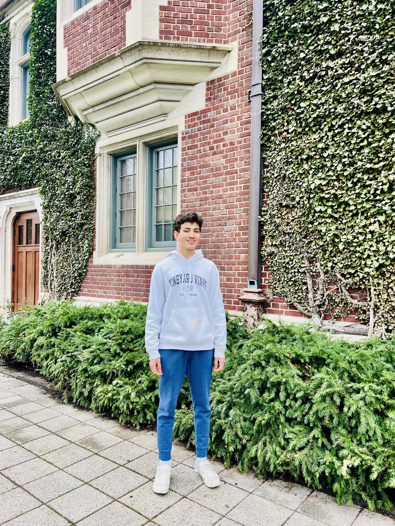 Standing in an ivy-covered courtyard during a college visit